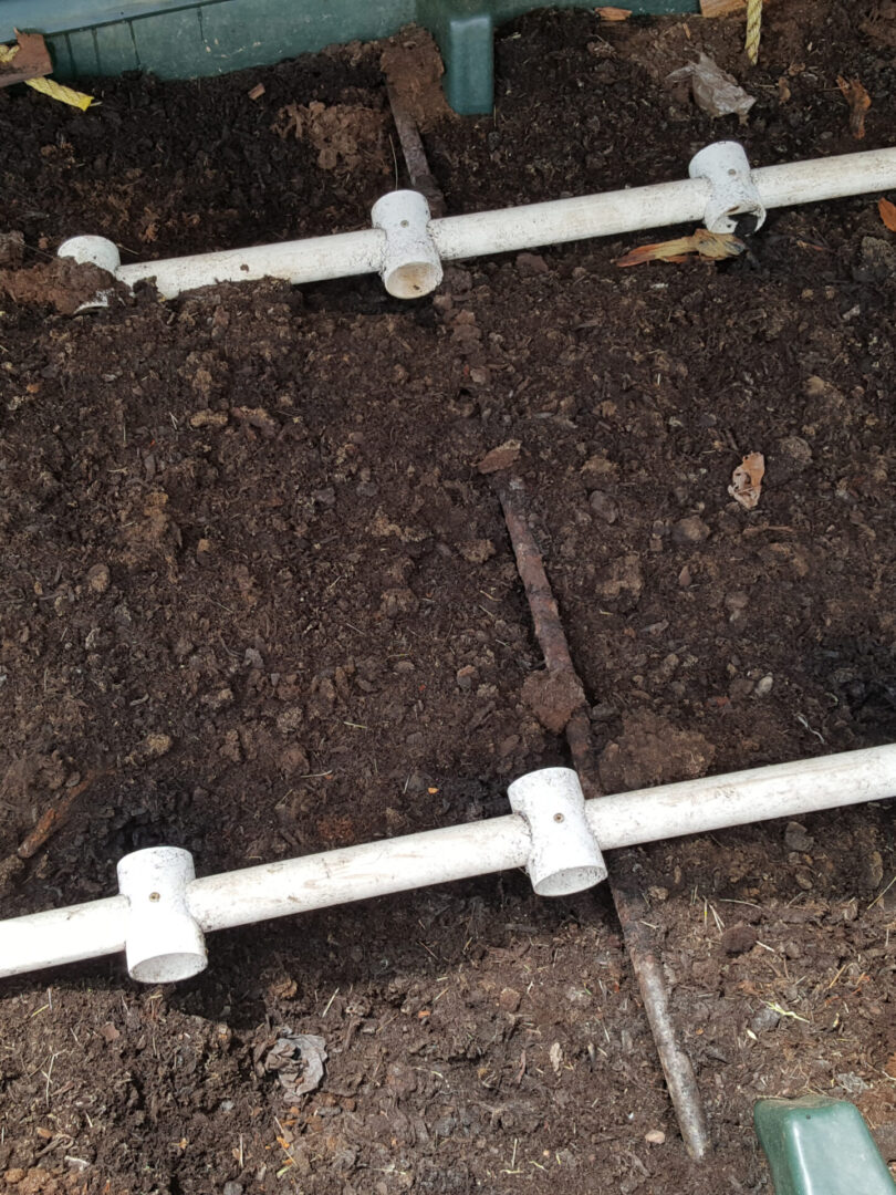 A close up of the ground with pipes in it