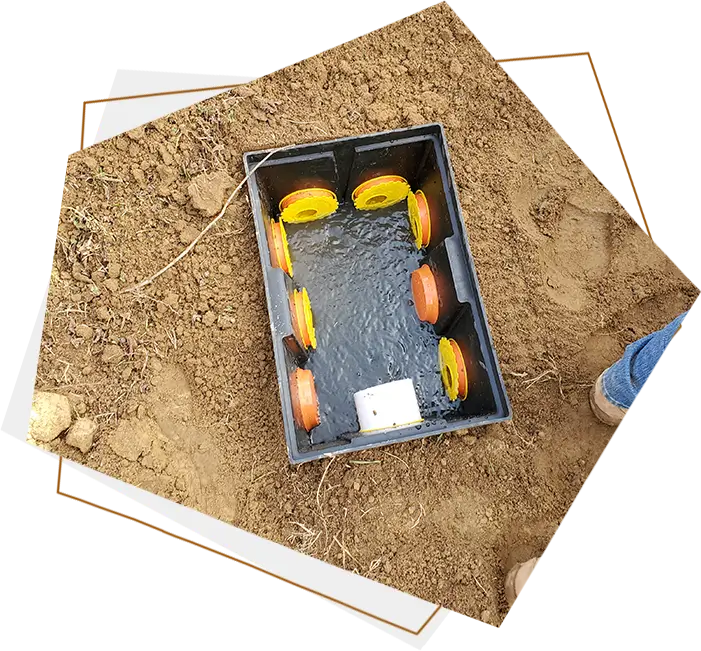 A person standing in the dirt with an empty box.